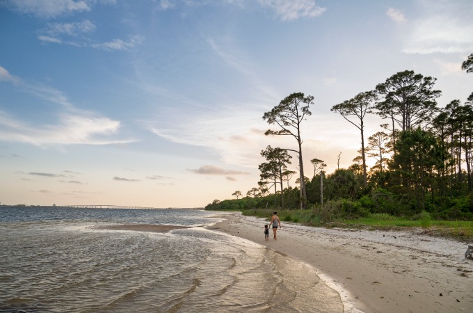 mother and son walking down the shoreline at the Naval Live Oaks Area