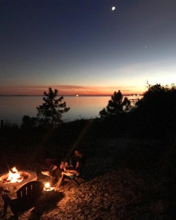 Curling up by the fireplace near a cozy beachfront