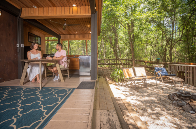 couple enjoying a drink on open-air cabana porch